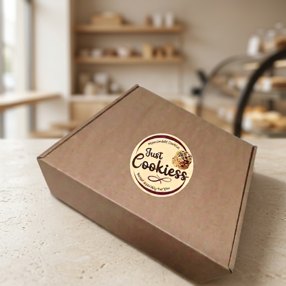 Just Cookiess branded cookie box on a pale stone countertop with a warm bakery-style background